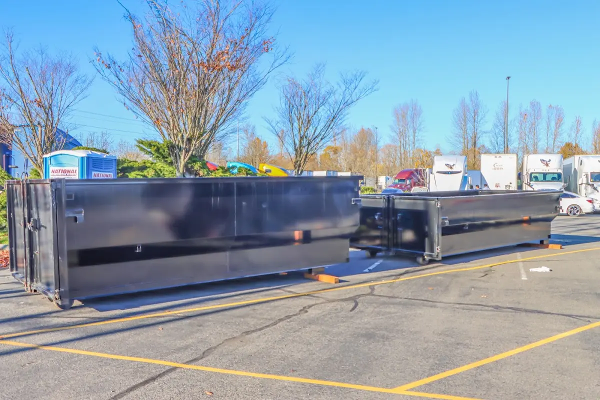 Professional dumpster rental service with roll-off container on residential driveway in Tyler